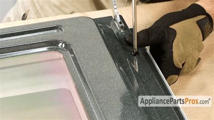 How do you put a Whirlpool oven door back on?