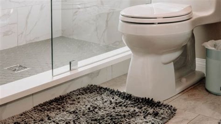 How do you remove the bolt cap on a Kohler toilet?