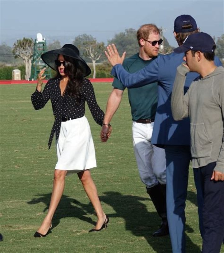 
Meghan Markle Kisses Prince Harry During Glamorous Polo Tournament Appearance 