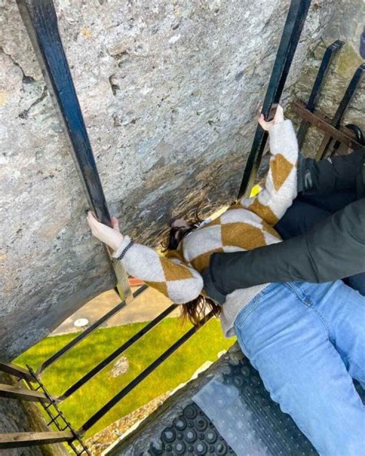 Why do you hang upside down to kiss the Blarney Stone?